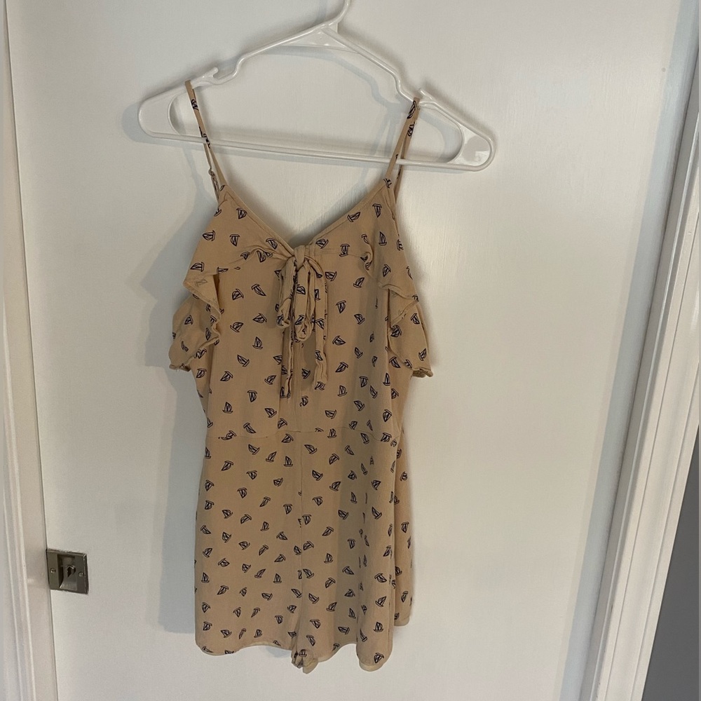 A cute summer tan romper with blue sailboats, light weight fun romper!